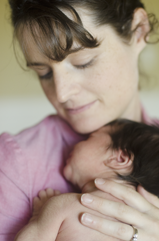 A mother cherishes a newborn baby.